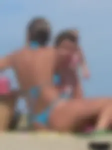 Sexy lady on the beach in a blue thong bikini