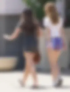 Sexy teen with glasses showing ass cheeks in shorts and friend in tight dress