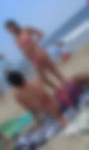 Pierced nipples hottie in pink at the beach