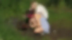 Cute Girl in a Dress Bending Over BBQ Grill in the Countryside Creepshots