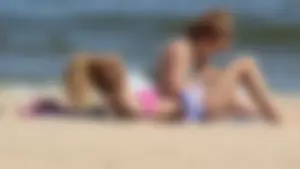Two sexy beach teens in bikinis, one thick and one skinny with big boobs