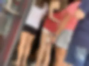 Bunch of girls in various outfits at a Cardinals baseball game