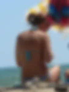 A bunch of hot babes on the beach in thong bikinis
