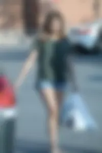 Cutie walking in the parking lot in jean shorts