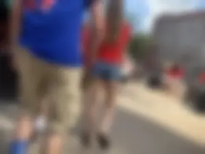 Bunch of girls in various outfits at a Cardinals baseball game