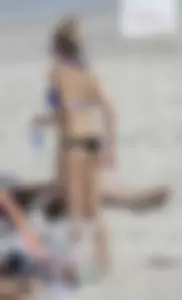 Florida blonde in blue and black bikini on the beach