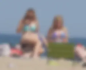 3 girls on the beach in bikinis with big boobs, one brunette and two blondes