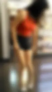 Sexy brunette trying on shoes in shorts with a great ass