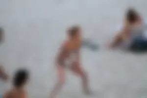 Sexy girl playing beach volleyball in a bikini