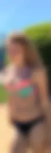 Adorable and sexy teen in colorful bikini at a water park