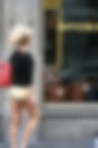Blonde looking sexy walking in short yellow shorts