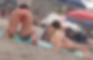 Pink and patterned bikini girls' asses laying on the beach