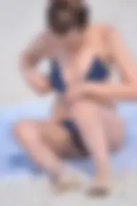 Blue bikini girl on the beach with a great ass and a little pussy lips slips