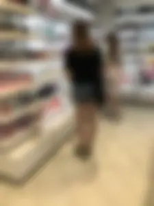 Skinny candid teen's legs and booty in denim shorts closeups at the store