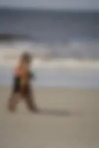 Skinny cute blonde on the beach in yellow bikini