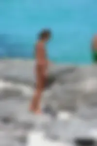 Older lady on a nude beach showing her body