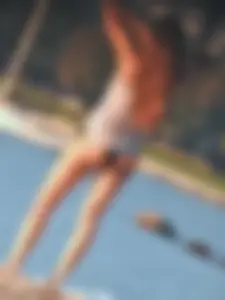 Sexy beach girl in a Nike sports bra and black bikini bottom