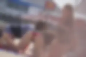 A group of teens in bikinis on the beach