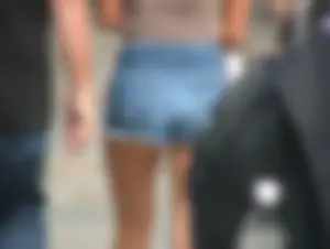 Cute girl showing her cheeks in short denim shorts