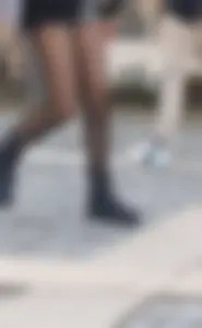 Sexy legs in ripped black pantyhose street closeups