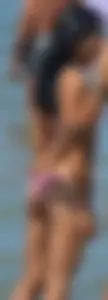 Little brunette ass in a pink bikini at the beach