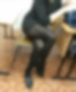 Teen in a Dress and Black Pantyhose Sitting with Legs Crossed in Classroom Candid