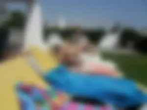 Girls in Swimsuits Lying on Sunbeds Poolside Candid Photos