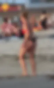 Thick white girls ass in a black thong bikini at the beach