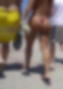 Big booty babe walking by the beach in thong