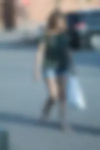 Cutie walking in the parking lot in jean shorts