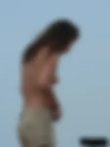 Sexy babe with a nice body topless and in a thong on the beach