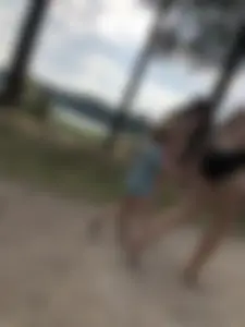 Cute Barefoot Girl in a Black Body Swimsuit Walking on a Road