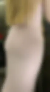 Blonde college girl with a baby face in a very tight dress