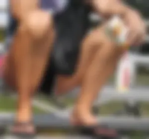 Girl in Shorts And Slippers Sitting With Spread Legs at a Street Sporting Ground Creepshot - Her Crotch Clearly Visible
