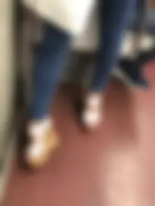 Candid girl wearing tight blue jeans and sandals on high platforms