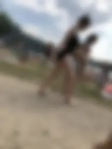 Cute Barefoot Girl in a Black Body Swimsuit Walking on a Road