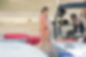 Brunette on a boat in red thong bikini with a tight little ass