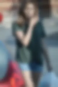 Cutie walking in the parking lot in jean shorts