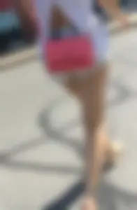 Sexy babe in short jeans shorts on the phone
