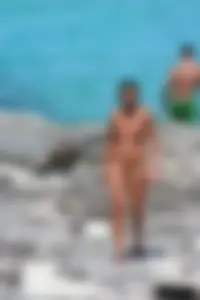 Older lady on a nude beach showing her body