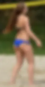 Cute girl playing volleyball in her little bikini