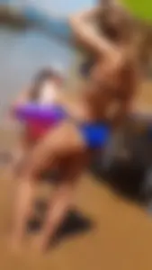 Young cutie wearing a blue swimsuit at the beach photos
