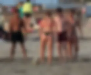 Thick white girls ass in a black thong bikini at the beach