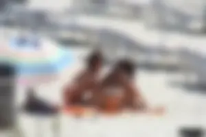 Topless milf and her topless daughter on the beach