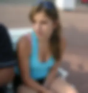 Girl leaning over to show off her nice tits while sitting on a bench