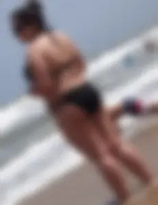 Thick beach girl in black bikini with big ass and tits