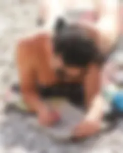 Cute brunette lady topless at the beach with awesome tits