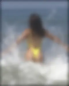Sexy ass beach babe in a yellow thong swimsuit