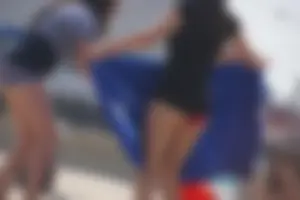 A group of teens in bikinis on the beach