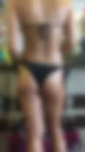 Oiled up thong bikini in store